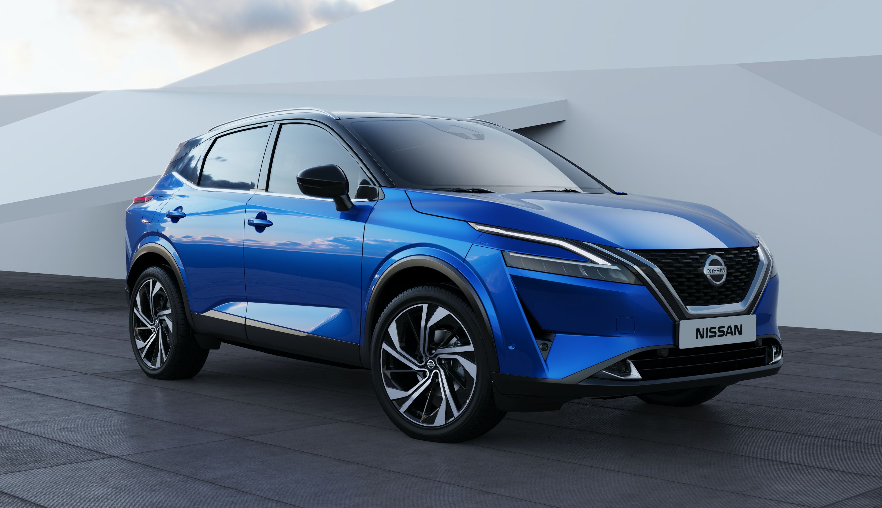 Blue Nissan Qashqai in a manufacturer studio setting